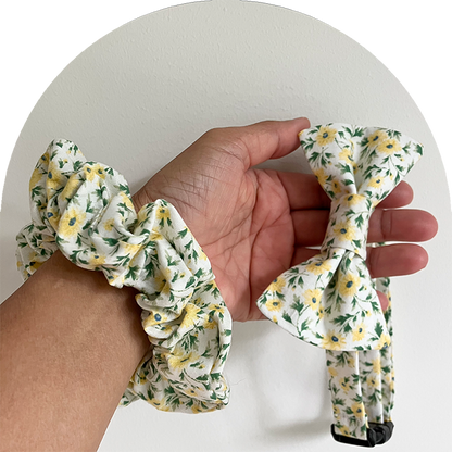 Matchande husdjursfluga och ägarens scrunchie med blommigt mönster i gult.